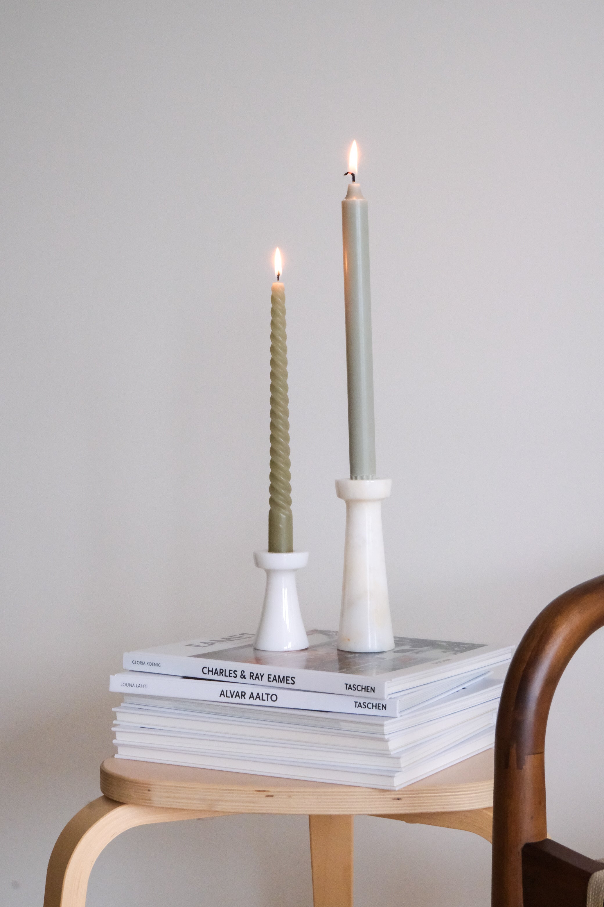 Set of Lyla marble candle holders with intricate details, styled together to enhance a modern and elegant decor setting.